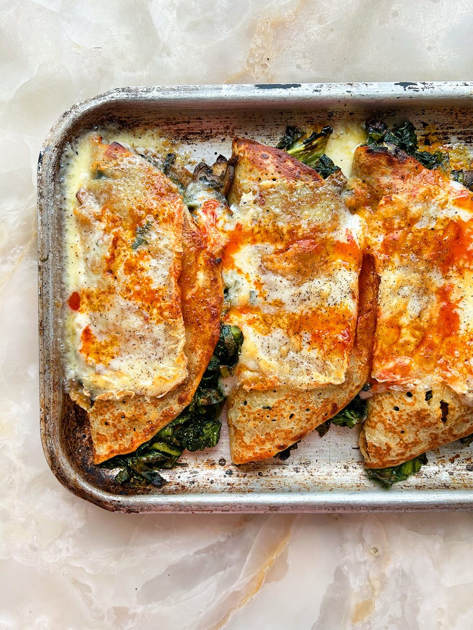 Grilled pancakes with harissa cabbage and taleggio