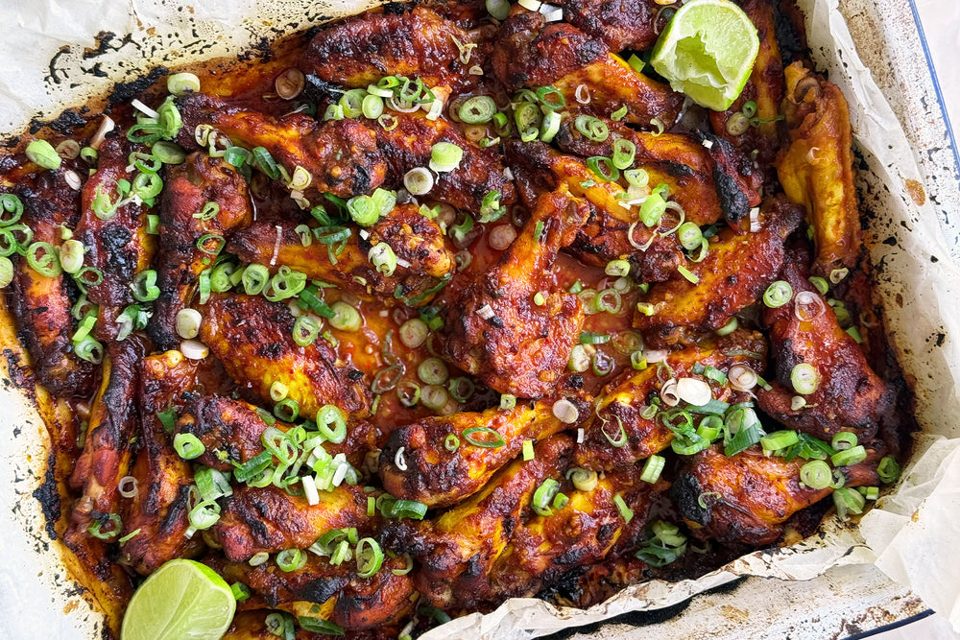 Sweet and smoky chicken wings with spring onions and lime